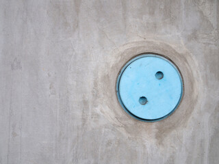 blue pvc pipe cover on gray concrete wall or large pillar