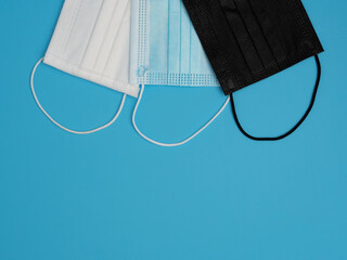Colored surgical masks. Copy space. Blue background.