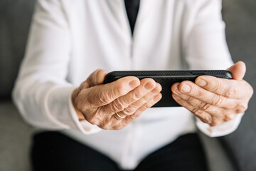 Obraz premium Smiling senior woman having video call on smartphone