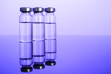 Glass vials on a dark background, vaccine against influenza, virus, coronavirus