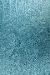 Fototapeta na wymiar Ice crystals on glass in winter