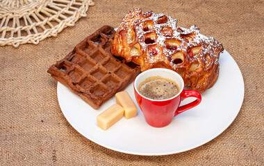 Pastries and espresso coffee on a burlap background