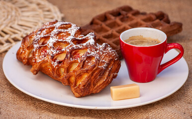 Pastries and espresso coffee on a burlap background