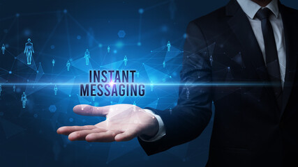 Elegant hand holding INSTANT MESSAGING inscription, social networking concept