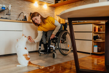 Woman in a wheelchair with her cat