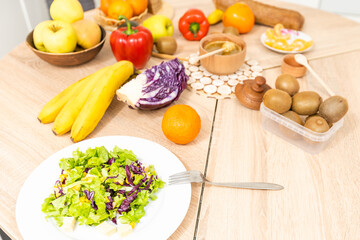 fresh fruits and vegetables on the table in kitchen interior, healthy food concept