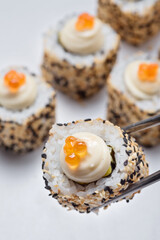 Roll with shrimp tempura, seeds, caviar