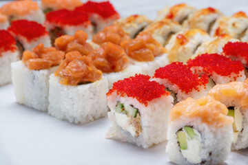 Sushi set with tuna, shrimp, salmon, and rice on the dark background