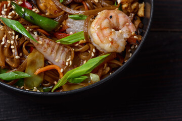 Ramen noodles with shrimp in bowl closeup