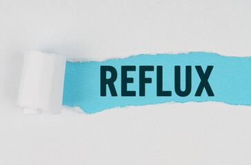 In the middle of a white sheet of paper, a tear is made under which, on a blue background, the inscription - REFLUX