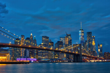 Brooklyn Bridge with panoramic views of  Manhattan at night, New York City, USA