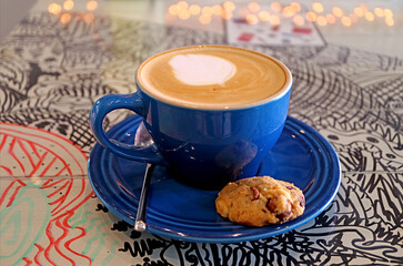 Cup of cappuccino coffee with a choco chip cookie isolated on the table	