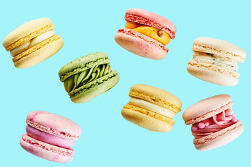 Close up of Traditional french cookies macarons of different colors and taste isolated on blue background. Sweet cookies macaron. Mockup for the card on the celebrated birthday.