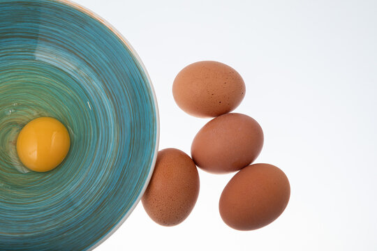 Fresh egg raw in blue bowl on white background Top view