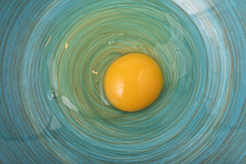 Fresh egg raw in blue bowl . Top view