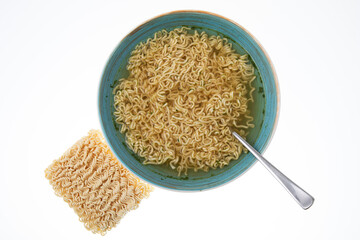 Bowl of instant noodle soup with silver spoon