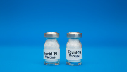 Coronavirus vaccine concept isolated on blue background.  Covid-19, 2019-nCov pandemic.