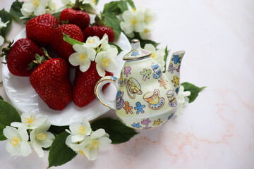ripe ripe strawberries on a white plate and jasmine flowers 