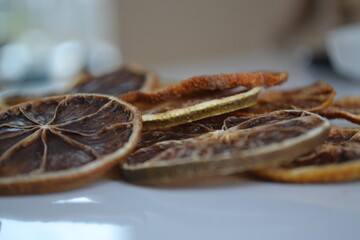 Dry slices of red grapefruit lie on the table