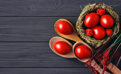 colored deep red Easter eggs in nest top view background, selective focus image. Happy Easter card	
