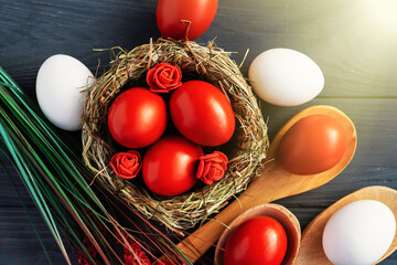 colored deep red Easter eggs in nest top view background, selective focus image. Happy Easter card	
