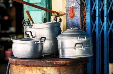 Metal dishes on the street in a poor area of Thailand