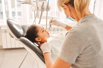 Child patient sitting at the clinic during examination