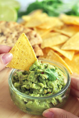 Delicious Homemade guacamole with tortilla chips and flat bread