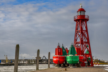 Fototapeta na wymiar Lighthouse and harbour lights of the harbour of Den Oever, The Netherlands.