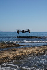 Fototapeta na wymiar Drone in operation taking pictures of the beach, in Alicante, Spain