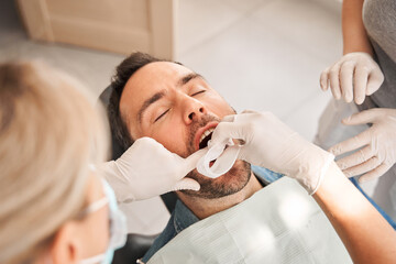 Dentist prepares the patient and tools to remove tartar