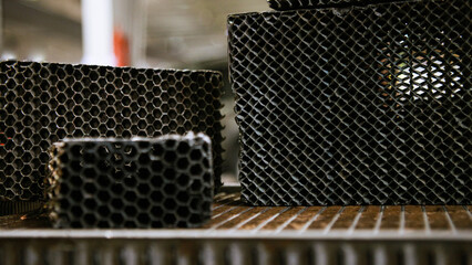 A set of vintage car radiators with Honeycomb and square shaped core on a table