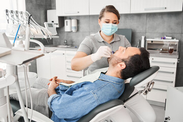 Dentist taking dental impressions of caucasian man