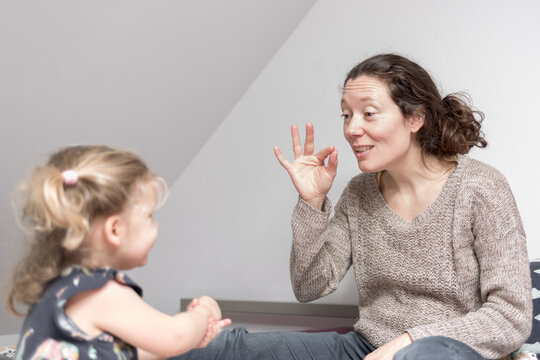 m&egrave;re et fille signe une comptine en LSF