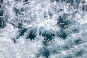 Fototapeta na wymiar Ocean surface background with waves and foam.