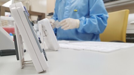 Equipment in laboratory with background of medical lab scientist working in hospital.