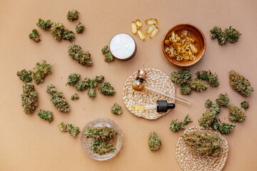 Fototapeta na wymiar Medical marijuana buds with oil and glass pipe. Top view, flat lay