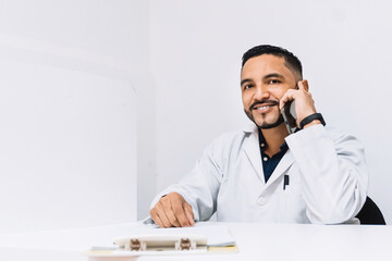 adult man dressed as a doctor or dentist, holding a phone. Online communication concept.