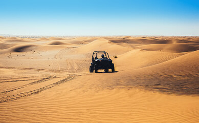 Buggy quad bike ride forward ahead at desert sand, leave tracks, beautiful nature wild landscape, outdoor off road driving  © mynoemy1