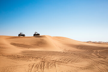 Fototapeta na wymiar Quad buggy vehicles race at Al awir desert near Dubai, UAE, extreme sports transport, driving off-road
