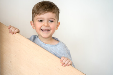 Child standing on stairs, playing and laughing