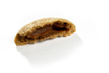 a half of cookie filed with chocolate on white background, side view