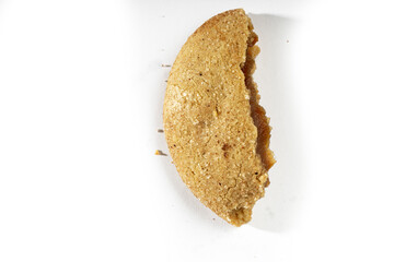 a half of cookie filed with chocolate on white background, top view