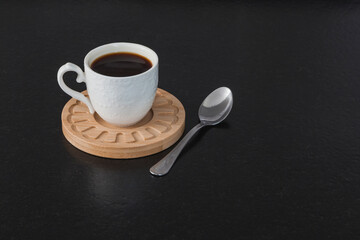 Obraz na płótnie Canvas Cup of coffee on a black surface