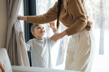 Woman catching son while playing at peekaboo