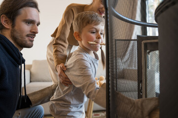 Obraz premium Family spending their free time near the fireplace