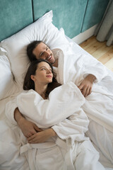 Couple lying on the bed and looking romantic