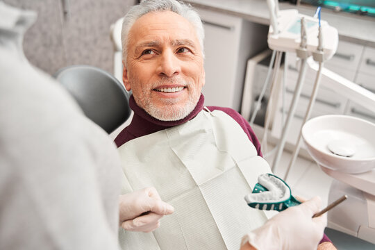 Dentist showing to patient dental impression