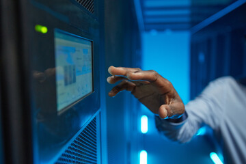 Close up of hand reaching for control panel at server cabinet while operating supercomputer, copy...