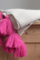 stylish and cosy blanket on wooden drawers 